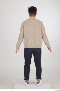 Yoshinaga Kuri blue jeans brown sweater casual dressed standing white…